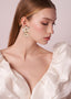 Double flower and pearl gold stud earring on model side view