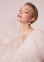 Gold floral accented pearl stud earring on model in tulle dress