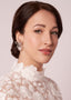 Swarovski crystal open flower and pearl stud earring on model in lace dress