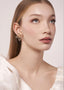 Swarovski crystal floral stud earring in gold on model with sleek hair