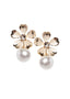 Flower and pearl gold stud earring on white background