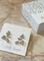gold floral crystal earring on blush marble background