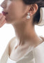 Crystal and oversized pearl stud earring on bride