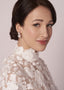 double pearl stud earring on model wearing lace dress