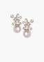 A pair of pearl stud earrings with Swarovski crystal top on a white background