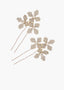 Gold hairpins with floral designs on a white background