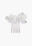 Hair comb with white floral attachments and pearls on a white background