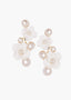 Pearl earrings with white floral designs on a white background